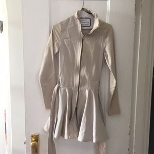 Fitted trench coat with flirty skirt